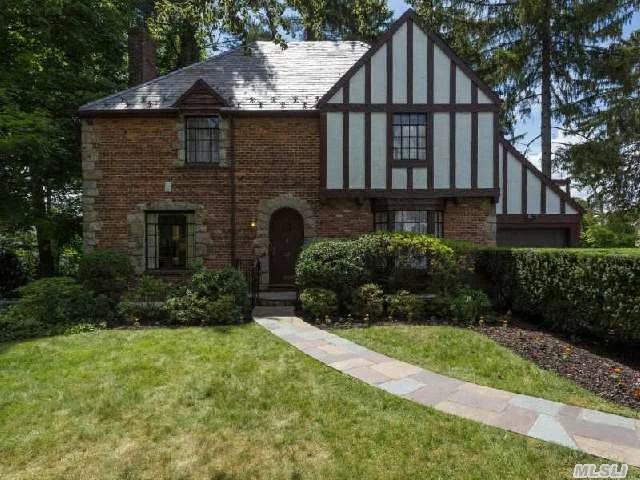 Classic Three Bedroom Tudor With Lovely Curb Appeal. Inviting Living Room With Fireplace And Adjoining Porch, Formal Dining Room, Kitchen With Breakfast Area, Full Bath. Master With Master Bath And Two Additional Bedrooms With Bath On Second Floor.