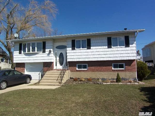 Updated Waterfront Home Features 75 &rsquo; Of Bulk Heading, Wide Canal, Updated Kitchen And Bath, Skylight In Kitchen With Sliders To Trek Like Decking To Beautiful Wide Canal, Updated Windows, Roof, , Oak Floors, Downstairs Has A Separate Room For A Bath With Waste Line Already In, Igs, Double Driveway, Great House