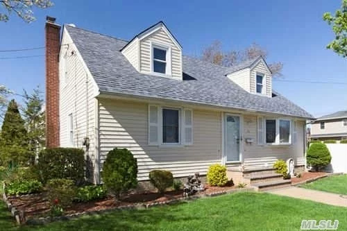 Beautiful Cape Cod Home Situated On A Corner Property. 1st Fl Large Lr W/ Bay Windows, Fdr W/ Sliders To Yard, Large Eik W/ Open Floor Plan, Master W/His & Her Closets, Bedroom & Full Updated Bath. 2nd Fl 2 Large Bdrms. Large Basement (Mostly Finished), Hardwood Floors Throughout, Gas On Block For Easy Conversion. Newer Windows & Roof. Moments To All Parkways & Transporta