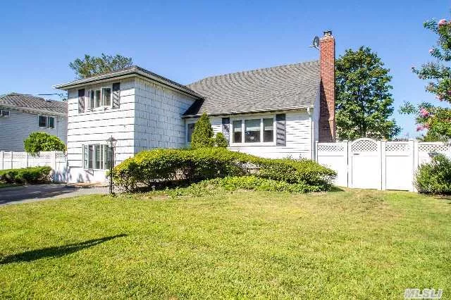 Lovely Split Home In Massapequa. Features Include 5 Bedrooms, 2 Full Baths, Living Room With Fireplace, Wood Floors, Formal Dining Room, Eat In Kitchen, Large Deck Off Back, Den With Side Patio, Upper Addition Added W/ 2 Bedrooms & Laundry. Possible Mother/Daughter With Proper Permits, Check With Town. Sprinkler System, Pvc Fencing.