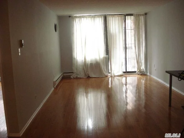 Renovated Large 1Br Co-Op At In Downtown Of Flushing, Between Main St & Maple Ave, Convenient To All, Hardwood Floor, Sliding Door To Balcony, Lots Of Closets, Well Maintained Building.