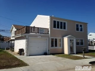 2-Story House On Double Lot With Yard On Both Sides. Bay & Canal Views. Tile Floor Throughout First Floor--Den, Wet Bar,  Diningroom, 2 Bedrooms, Bath, Utility Room With Washer/Dryer. Upstairs Is Livingroom With Vaulted Ceiling, Kitchen That Opens To Upper Deck, 2 Bedrooms, And Bath. New Carpet Upstairs. Garage.