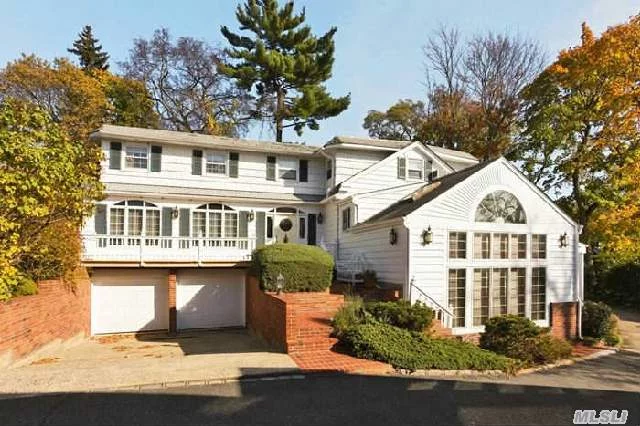 Plandome Heights Elegant Colonial. 5 Bedrooms, 2.5 Baths, 2 Car Garage. Living Room W/Beamed Ceiling, Dining Room, Kitchen With Fireplace, Sunroom, Cathedral Ceiling Family Room And Recreation Room. Sunny, Windows Galore. Gas Line On Driveway.
