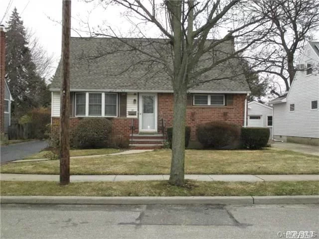 Well Maintained Cape In Tree Section On Quiet Street. Updates: Roof @ 1 Yr, Newer Siding, Replaced Windows. Updated Kit W/Oak Cabinets & New Gas Stove. Newer Washer/Dryer. Fresh Paint 1st Fl, Refinished Hw Fl. Newer Exterior Doors. Screened In Rear Porch. East Street Elem. Convenient Bus, Lirr, School & Shops. Low Taxes