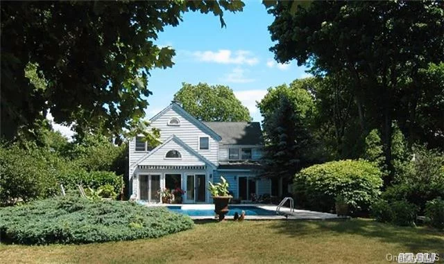 Updated Turn-Of-The-Century Elegance On Mattituck Inlet With Saltwater Pool & Dock - This Graceful 3 Bedroom, 3 Bath Home Has Been Stylishly Renovated And Includes A Chic Sunroom, Charming Livingroom With Fireplace, Beautiful Eat-In Farm Kitchen, Captivating Landscaping With Brick Patios, Decks, And Pool. A Truly Magical Retreat! Near Love Lane Shopping & Transportation.