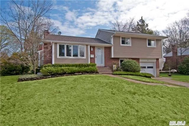 Beautifully Updated And Expanded 4 Bedrm 2 Bath Home. Wood Flrs Throughout, New Kit W/Corian Counters & New Appliances, Large Expanded Den W/Fireplace Leading To A Trex Deck & Over-Sized Backyard. Dead End Street Close To Town & Lirr. Commuters Dream!