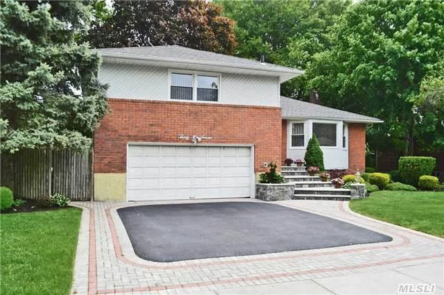 Beautiful Brick Split, With 3 Good Size Bedrooms, Master W/Full Bath, 2 Additional Bedrooms With Updated Hall Bath, New Eat In Kitchen W/ Skylight, Formal Dining Room W/Sliding Doors To New Maintenance Free Trex Deck, Living Room, Hardwood Floors Throughout, 2 Car Attached Garage, 70 X 100 Professionally Landscaped Property.