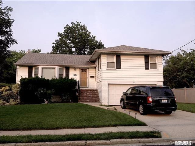 Designed With A Unique Wide Open Hall Entrance & Wonderful Split Levels, This Home It Features Hard Wood Floors Throughout, Master Br. With Full Bth. Fabulous Open Living Spaces Like Bright Dr. & Family Room W/Fireplace & Access To Enjoyable 2 Car Garage And A Perfectly Manicured Green & Healthy Grass Yards- Full Size Bsmt. New Steel Supporting Beams, New Roof & Electric.