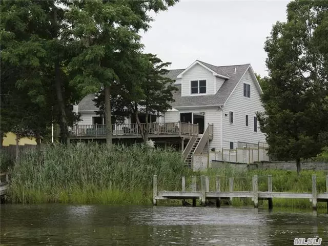 Lovely Water Front Non-Traditional Home On Goose Creek. Easy Access To Peconic Bay. Open Concept W/Sliders In Lr & Kitchen That Lead To Huge Waterside Deck W/Awning. 4 Large Bedrooms Including 1st Floor Master Ensuite & Guest Quarters With Private Entrance, Full Bath & Covered Patio. Private Floating Dock.