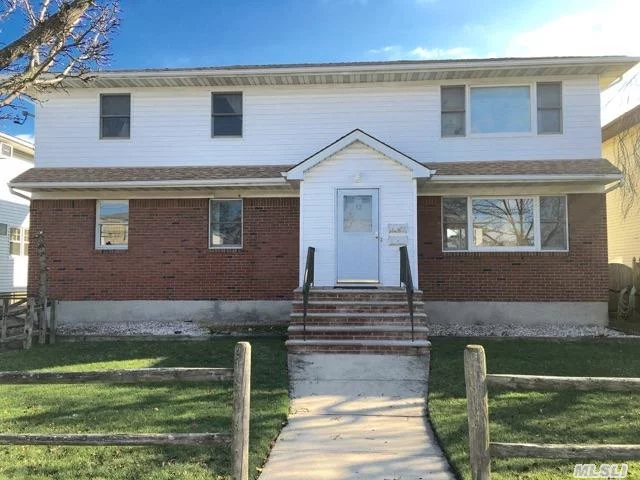 Bright Spacious Legal 2 Family Located On The Water. Two Car Garage, Fenced In Backyard, New Heating System For Both Units. No Sandy Damage. Motivated Owner. Property Also Comes With Docking Rights.