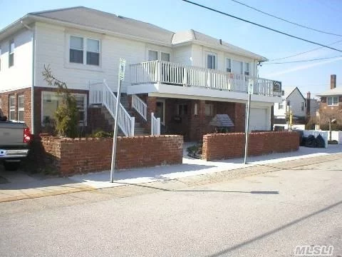 Main Floor Apartment In Beachside Corner House Has Front Porch W/View Of The Beach & Ocean. Livingroom-Diningroom, Kitchen W/Dishwasher, New Microwave,  Washer/Dryer, 3 Bedrooms & 2 Baths. Private Beach Pass Included. I Parking Space.