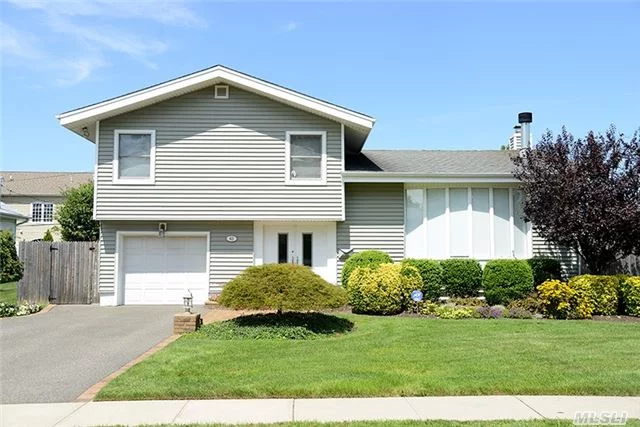 Nicely Tucked Into The East Birchwood Section Of Jericho, This Mid-Block Split Is In Move In Condition. Updated Kitchen Showcases Double Ovens & Ss Energy Efficient Appliances. The Main Level Features Gleaming Hardwood Floors That Flow Throughout. Sliders To Deck, 2 Zone Cac, Updated Windows, Cedar Closet And Alarm. Great Yard For Entertaining.