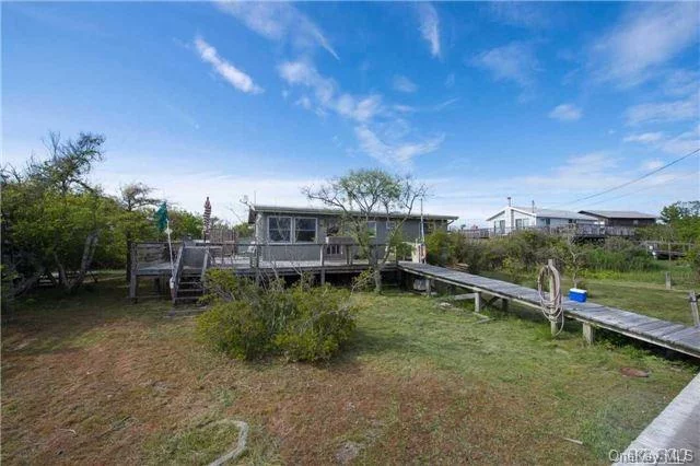 Quaint And Beachy Single Story Beach Bungalow/Cottage In Ocean Ridge Section Of Davis Park;East Of The Marina. Large Wrap-Around Deck Wrapping From West Side To South Side. 4 Bedroom, 2 Baths, F/P, Outdoor Shower And W/D. Quick Walk To The Beautiful And Unique Ocean Beach Which Runs The Entire Length Of The Island. Walk To All Amenities