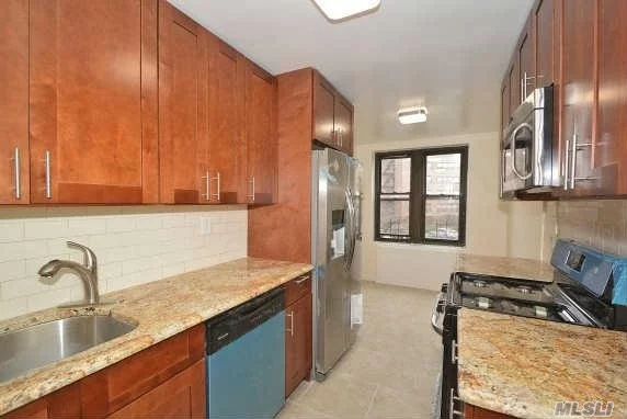 Extra Large Totally Renovated 2 Bedroom W/Bath & Powder Room. Gleaming Hardwood Floors, Closets Galore. Brand New Renovated E-I-K. Central Air/Heat. Reserved Parking Included In Sale. Conveniently Located; Express Bus To City Right Outside Your Door, Minutes To The Lirr. Top Rated S.D#25. A Must See!