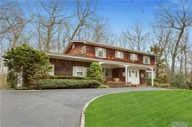 Situated On Two Acres Of Lush Level Laurel Hollow Property, This Lovely Five Bedroom Colonial Welcomes You Though A Large Entry Hall. Entertain In The Light And Bright Living Room And Formal Dining Room With Gleaming Hard Wood Floors. Relax By The Fire In The Den Which Is Connected To The Spacious Kitchen. Laurel Hollow Beach And Mooring And Conveniently Located To All.