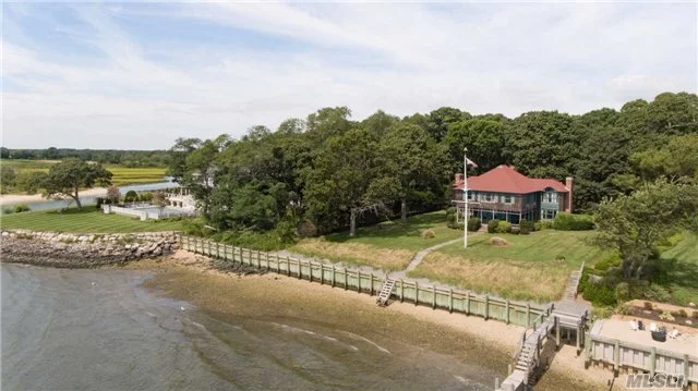 Exquisitely Detailed Turn Of The Century Post And Beam Home W Standford White Flair. This Grand Bay Front Lady Located In Coveted Fleets Neck, Sits On 1.4 Ac, Boasts 189Ft Of Waterfront, New Bulkhead, Pvt Dock, Detach Oversized Garage W Loft. Solidly Built 4 Bdrm, 2 Bath,  Cac, Gas Ha. Updating Will Restore This Golden Oldie To Its Original Grandeur.