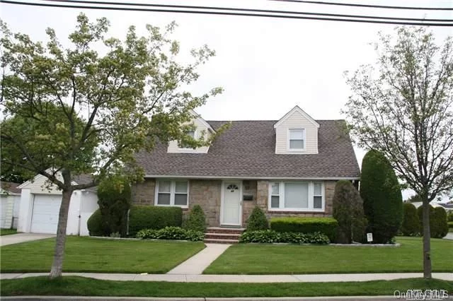 Move Right In To This Very Well Maintained 6 Rooms Cape. 4 Br, 1.5 Bath. Stainless Steel Kitchen Appliances, Frontload Washer & Dryer, Under Carpet Is Hard Wood Floors. Full Basement With Outside Entrance. Central Air, Alarm, Ing Sprinklers. Fieldstone Brick/Frame W/Single Layer Roof. Professional Landscape Yard. Patio. Att 1 Car Garage W/Breezway. Excellent Curb Appeal.