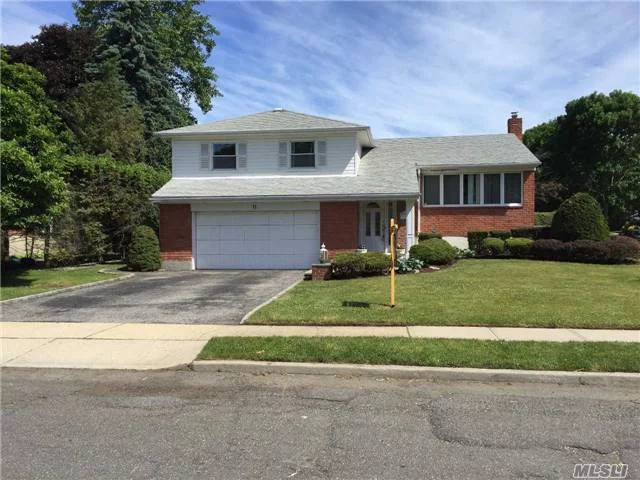 Spacious Perfectly Located Joseph Martin Split Level. Gas Cooking And Heat. Country Club Property On Shy 1/4 Acre. Best Value In Syosset Woods!