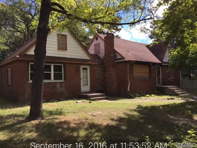 There Was A Fire That Damaged Most Of The Structure. The Right Hand Side Of The Structure Is Completely Stripped To The Studs, The Left Side Of The Asset Still Has Sheetrock Remaining, Basement Under The Main Structure Not Under The Converted Garage. Level Treed Corner Lot,