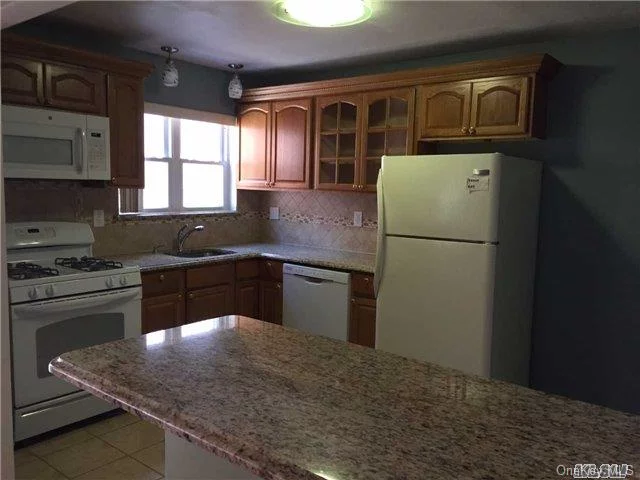 Updated 2 Bedroom Apartment, 1 1/2 Baths, Kitchen W/Granite Counters, Hardwood Flooring Throughout, Separate Entrance, Off-Street Parking, Coin Operated Washer/Dryer On Premises, Near Transportation And Shopping.