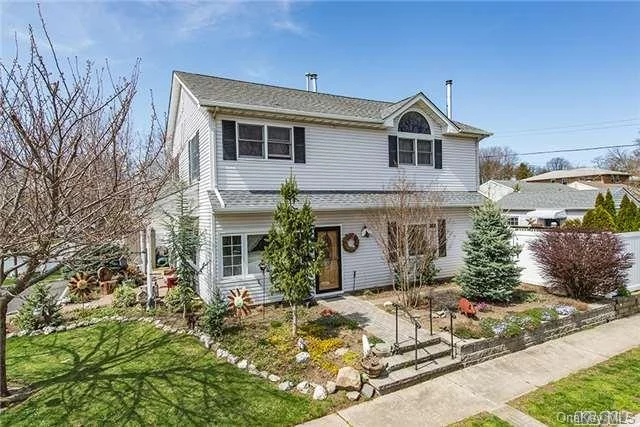 Beautifully Expanded And Renovated Colonial On A Quiet Corner Parcel Nestled At The Entrance To The Cul-De-Sac. Features Hardwood Floors, Updated Kitchen, Large Den With Wood-Burning Stove And Sliders To Yard, Guest Suite With Full Bath And Separate Entrance, Large Master Bedroom And Full Walk-Up Attic. Two Driveways, Central Air And Beautiful Landscaping.