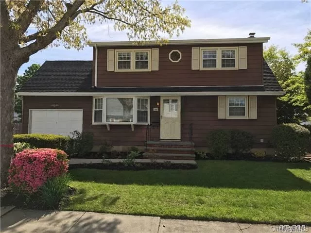 Lovely Well Maintained 5 Bedroom Colonial In A Quiet Residential Neighborhood, New Roof, Eik With Skylight, Hardwood Floors, Full Basement With Utility Room, Gas Cooking & Heating, 2 Zone Heating, Attached 1 Car Garage, Large Fenced In Yard With Roofed Over Cement Patio, In-Ground Sprinklers. Charles Campaign Elementary School. Close To Lirr And Neighborhood Park.