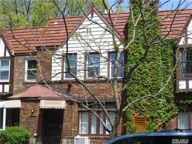 Charming Tudor Townhouse Located On Tree Lined Street In Prime Location. Fifteen Minute Walk From Express Train Service E, F, M, R Lines, Long Island Rail Road And Express Bus Service Nearby. Building Size Is 20 Ft By 40 Ft. Home Features Wood Floors Throughout, Fire Place, Renovated Kitchen, Sun Room, Spacious Bedrooms And Indoor Garage. A Lovely Place To Call Home!