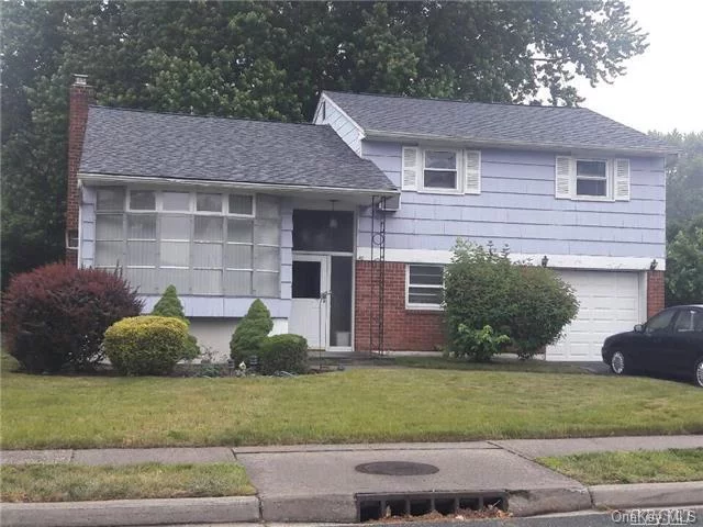 Syosset Woods Split Level Offering 3 Bedrooms, 1.5 Baths, Den/Family Room, Eik. Wood Floors Underneath The Carpet.