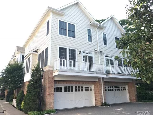 Sundrenched, Freshly Painted, Corner Town Home. 2 Brs 2.5 Bths,  Den , Hardwood Floors, Floor To Ceiling Windows, Stainless Appliances, Tons Of Closet Space. 2 Car Heated Garage. Close To Teddy Roosevelt Beach, Shops, And Lirr. Cac 3 Zones Tons Of Closets!!!! Walk Up Attic To More Storage!