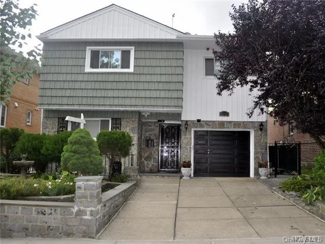 Sunny Spacious 4 Level Custom Built Tudor Style Split House On A Great Block! Super Clean And Shows Nicely! New Hardwood Floors Throughout, Finished Basement W/Sep. Entrance, Walk In Cedar Closet, Custom Big Closet, Skylight, Sun Room, Custom Built Fire-Place, Sky-Lounge On The Roof. Two Kitchens For Mother & Daughter, All Stone Paved Back Yard, New Granite L Counter Top.