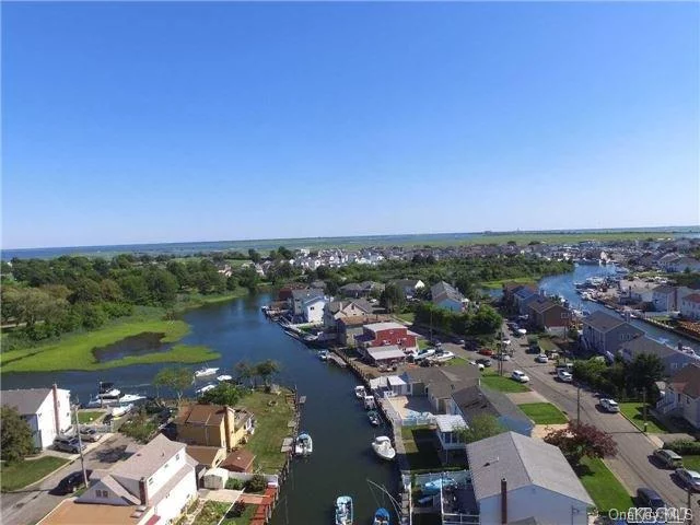 Boaters Delight. Hi & Wide & Handsome Waterfront Beauty. Just One House From The Tideway River. Squeaky Clean. Hardwood Floors Throughout Top Floor, New Granite Counter Top, Updated Baths. Large Bedrooms, Amazing 3 Season Room Overlooking Tideway River. New Tile Floors Throughout Downstairs, 2 Car Garage, 65&rsquo; Of Bulkhead.