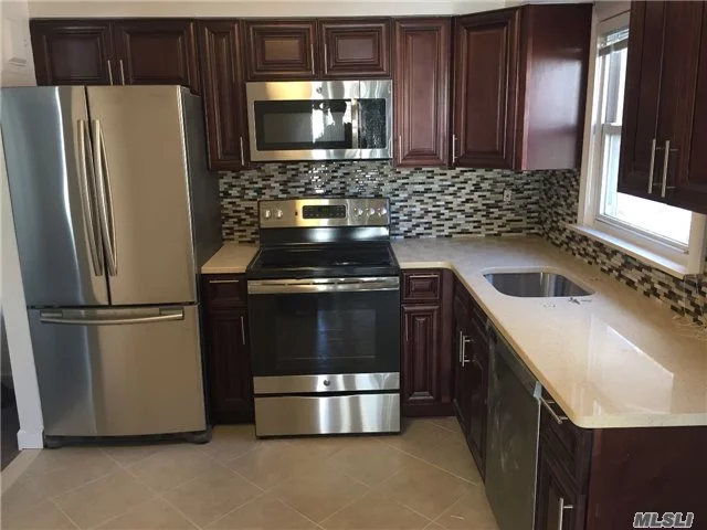 House Sized Luxury Living In This Newly Renovated 4 Bedroom, 2.5 Bath Triplex Apartment. Eat-In Kitchen, Stainless Steel Appliances, Granite Counters, Gleaming Hardwood Floors, Recessed Lighting, Custom Fixtures, Full Finished Basement With Half Bath, Washer/Dryer, Use Of Private Yard, Garage & Additional Parking Spot. Close To All... Sorry, No Pets Allowed