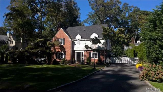 Welcome To The Flower Hill Section Of Manhasset Where A Beautiful Tree-Lined Street Welcomes You To This Lovely Center Hall Colonial With A New Kitchen, Living Room With Wood Burning Fireplace, Dining Room, Four Bedrooms, Three And A Half Bathrooms, Finished Basement And Attached Two Car Garage. Lush And Private Backyard. Munsey Park Schools.