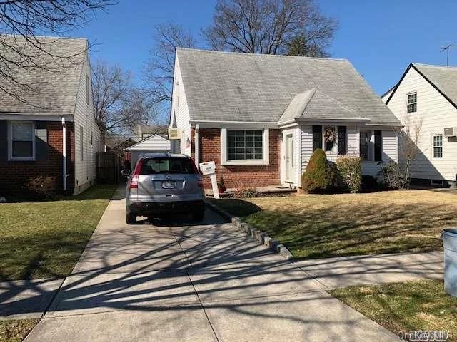 Wide Cape On Beautiful Block. Walk To City Bus And Bay Terrace Shopping Plaza! Original 3 Bedroom Converted To Two, (Easy To Convert Back). Hardwood Floors Under Carpet,  Sunny Eat In Extension Off Kitchen,  Detached 1.5 Car Garage With Plenty Of Parking In Driveway.