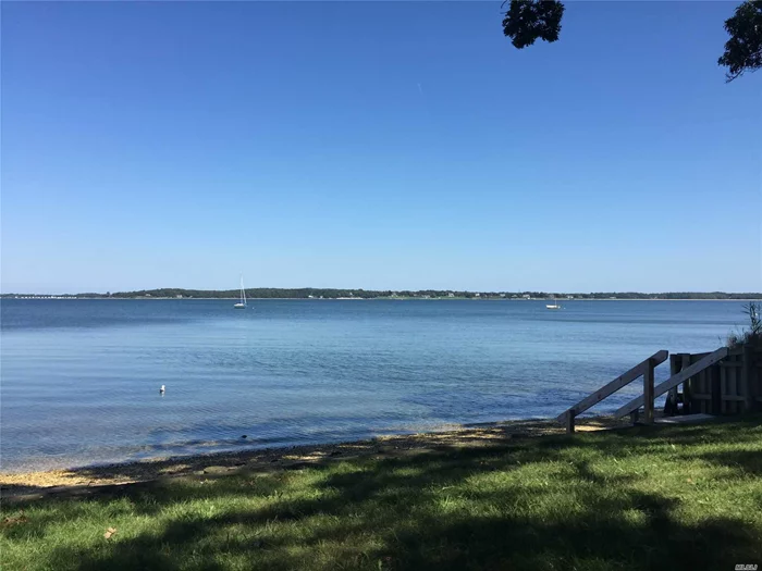 This Level Quarter Acre Lot Is Situated In A Serene Setting In The Quaint Paradise Shores Neighborhood. Enjoy A Short Walk To The Private Bay Beach With Quiet Picnic Areas And Expansive Bay Views. This Is The Perfect Spot To Build Your Own Summer Getaway.