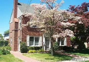 Brick Two Family On Oversized Lot. Second Floor Apartment Has Fir Place And Deck Off Kitchen.