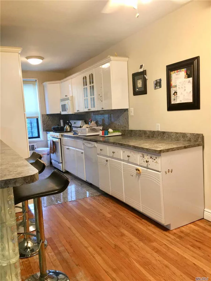 Designer Eat In Kitchen Featuring Custom Breakfast Bar, Gorgeous Hardwood Floors, Updated Bathroom, Window In Kitchen, Spacious Rooms, Loaded With Closets, New Doors, Pool, Super On Premises, Close To Shops & Transportation