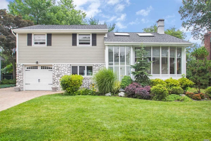 Spacious  Mid-Block 4 Bdr Split Level Located In Syosset Woods Community ! Note Low Taxes!! Pride Of Ownership! All Finished Hard Wood Floors, 10 Years Young Extended Eik W/Granite + Top Of Line Appliances .Double French Doors Lead To Two Decks And Lush Landscaping Offering A Peaceful Serene Private Backyard. Lr W/Bay Window + Woodburning Fireplace. Master Bedroom W 3 Custom Closets 3rd Bedroom Offers Unique Fun Loft.Newer Bathrooms. Finished Basement W Laundry Room. Gas On Street.