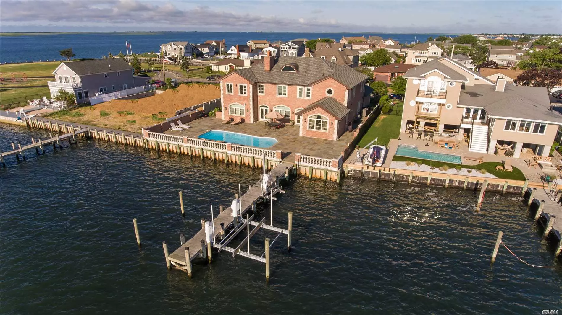 Majestic Brick Bayfront Home Built In 2008 With Every Amenity Known To Man. No Expense Spared & Only The Finest Materials Used. Savor The Beautiful Bayviews & Store Your Boat & Jet Ski Safely On The Lift On The 61 Foot Pier Then Take A Dip In The Saltwater Pool.  Livin&rsquo; L A R G E ! ! !