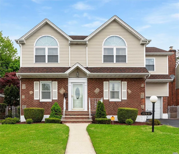 This charming XL 2-family property w/park-like grounds, nestled in the heart of Queens, MUST BE SEEN. It has Hardwoods throughout,  2 Kitchens, 2 LR/ DR Combos, 4 Bds, 3 Fbths, , jetted tubs, 2 walk-in Closets, 2nd fl. vaulted ceiling & Skylight, surround sound, finished Basement w/OSE, attached garage w/electronic opener and close to all forms of transportation. The unlimited other amenities, combined w/the unlimited new memories that can be made in this HOME, is REMARKABLE!