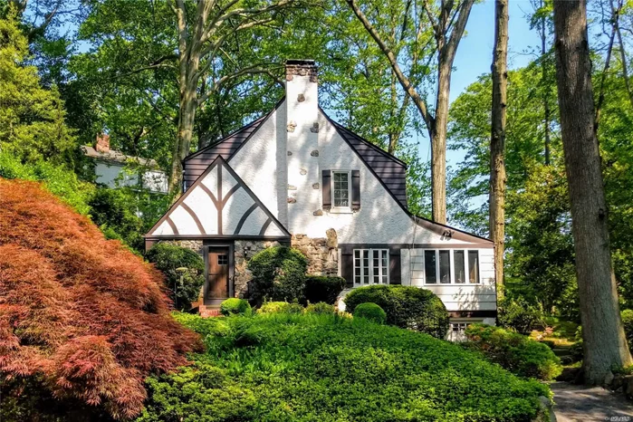 Tucked at the end of a quiet street, close to town, train and Pine St Park, this home has the charm of an English Cotswold Cottage. Inviting interiors w hand-hewn woodwork & ironwork. Entry foyer opens to beautiful oversized living room accented by built-ins and stone fireplace. Generous formal dining room, sun-filled orangery style den, master, 2 bedrooms, large updated bath. Turnkey home w new system and appliances. Beach Rights w dues. Taxes grieved w 11.33% reduction for 2020/21.