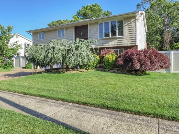 Great 4 Bedroom, 2 Bathroom home with a large property on a well maintained street. Updated baths with cathedral ceilings, hardwood floors, 2 car garage, plenty of light all with so much potential. Includes a Full paver driveway, Central Air Conditioning and newer roof.