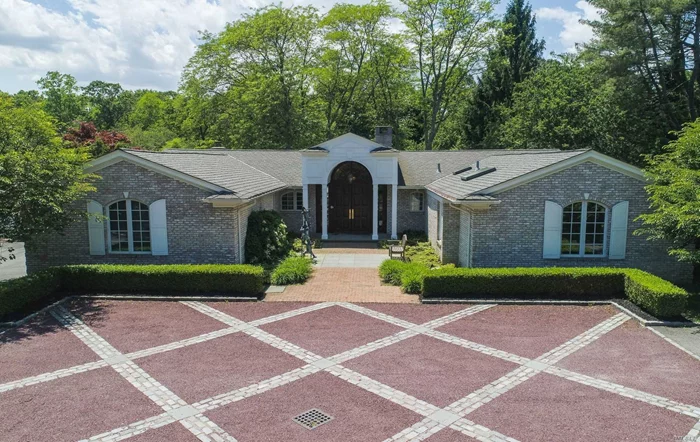 Expansive five bedroom ranch thoughtfully rebuilt with elegant details. Highlights include a generous great room, formal principal rooms and a culinary kitchen with top appliances, breakfast nook and desk area. Private master suite with two luxurious bathrooms. Exceptional landscape surrounds the in ground pool, hot tub and tennis court.  Home theater and 1200 bottle wine cellar set the stage for entertaining on a grand scale. Generator. Jericho SD.