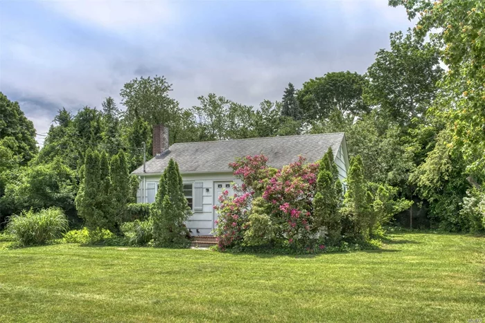 Charming 1950&rsquo;s Cottage on a beautiful .45-acre lot backing onto preserved fruit orchards, a short walk to town bay beach. Wood burning fireplace, hardwood floors throughout, original knotty pine cupboards in kitchen, full basement, freshly painted inside and out. Beautiful setting with room for a pool and to expand. Walking distance to Jitney & grocery.