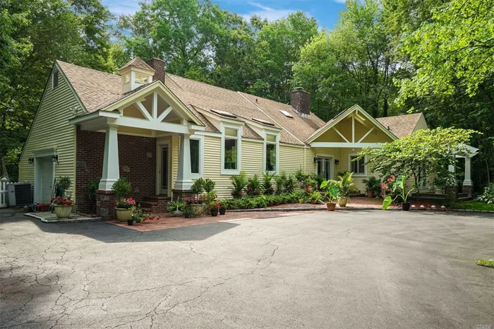 Tranquility at its finest. Abundant light streams through this eclectic home with walls of glass affording views of the lush landscape. Double doors and sliders from almost every room to private decks and brick patios. Relaxing lifestyle year round. CAC, Generator