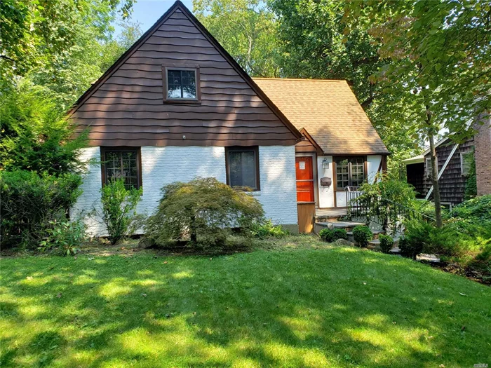 Spacious and bright Beacon Hill Tudor on large lot of 60x191. Large gourmet kitchen, first floor master suite with sunroom. Tons of charm, must see! Less than 1 mile to main street and LIRR. As-Is condition.