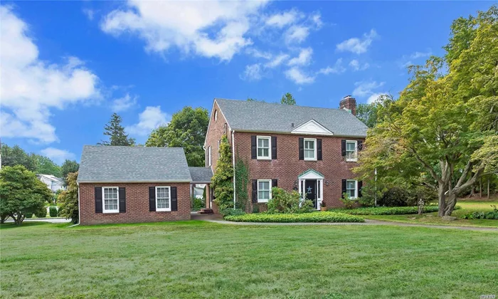 This impressive brick 1938 center-hall Colonial offers the original charm of pre-war homes w/ concave molding, artisan-crafted period staircase, cross cut wood floors & veranda combined w/ modern amenities including Central Air Conditioning, in-ground sprinkler system, granite kitchen, huge great room and an extraordinary ultra-luxe spa wing with cathedral ceilings, an exercise area, whirlpool tub, multi-jet shower and private balcony. With 2-car garage on 1/2 Acre, offers beaches & golf course.