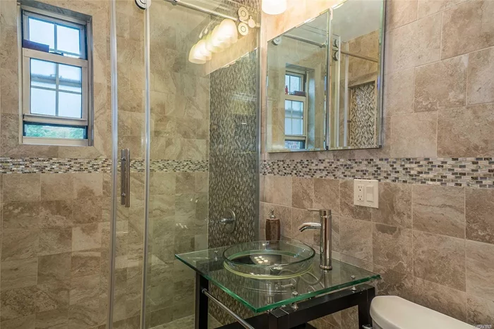 ***Welcome Home***To This Upper Corner Unit Featuring Hardwood Floors Throughout, Renovated Bath With Floor To Ceiling Tiles, Glass Enclosed Walk In Shower, Modern Glass Bowl Sink, Hi Hats...And More...