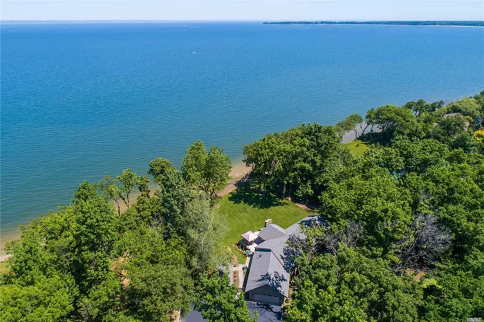 Waterfront Residence Sits Directly On The LI Sound W/ DIrect Access To The Beach! This Beautiful 4 BR, 3 Full Bath Ranch Has A Serene & Picturesque Setting, Warm and Inviting With A Stunning Great Room W/ Fireplace, Walls of Windows, Newly Updated Kitchen, Wood Floors & Full Finished Basement. Perfectly Situated on 2.15 Acres of Property W/ 168 Ft. Of Beach Frontage. Owners Installed Brand New Staircase To The Beach Below, Erosion Protection Structure, Sea Wall/Rock Revetment And Bulkheading. No CO for basementm decks and sheds. SHEDS ARE GIFTS.