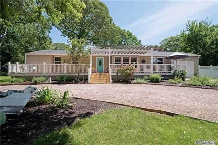 Located in the beautiful bay side beach community of Laughing Waters offering a private beach, picnic area & boat slips w/ launch ramp on Corey Creek. Easy access to Peconic Bay. South Harbor Park Beach is around the corner. Set on .67 acre lot. Relax on the front porch, back deck, patio, hot tub, outdoor shower & huge yard. Open concept living room and kitchen w/ a breakfast bar and wood burning stove. Master bedroom has a full bath. Full basement.